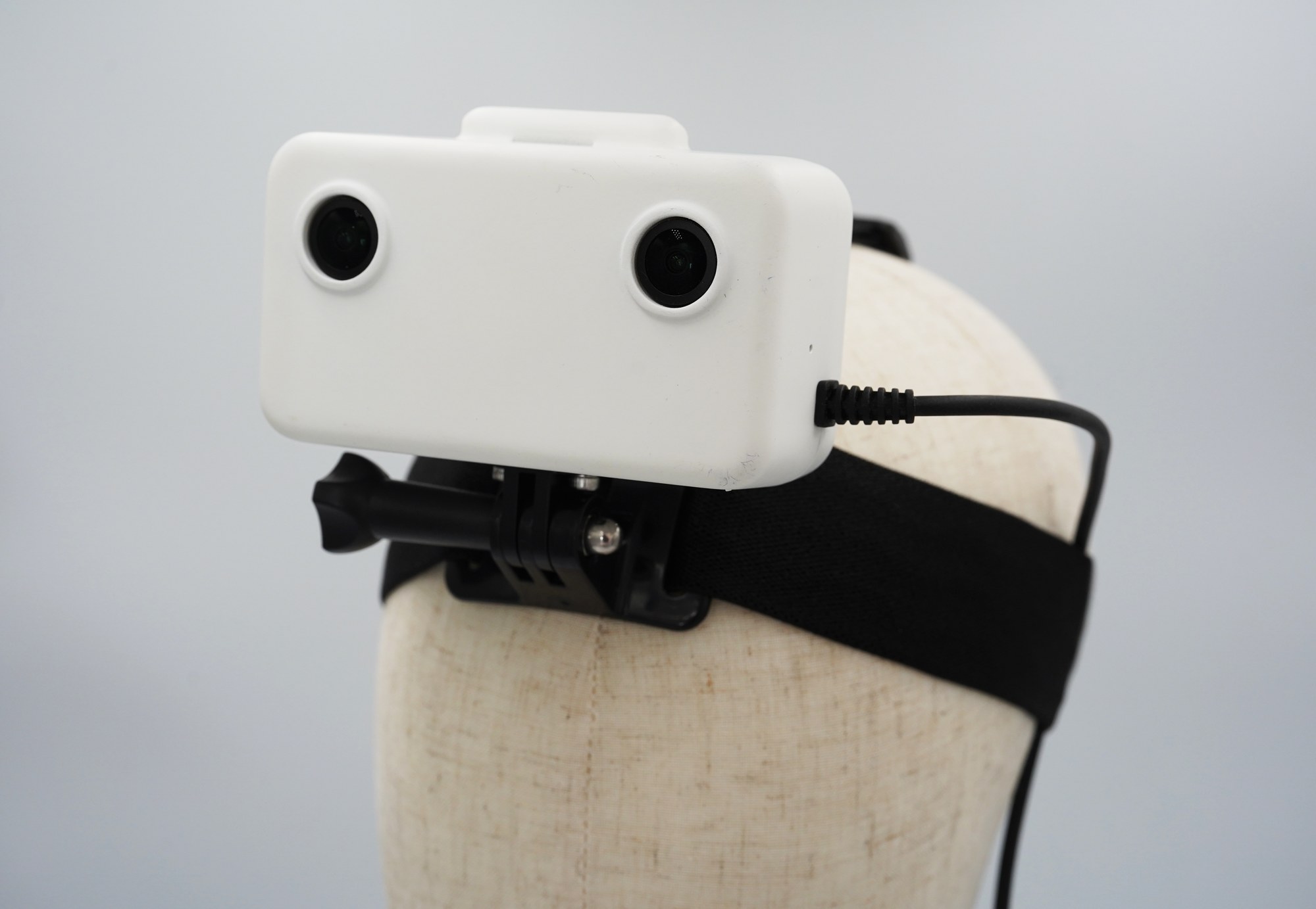 GI EGO1GS headset, three-quarter view showing the global-shutter stereo camera pair and elastic headband